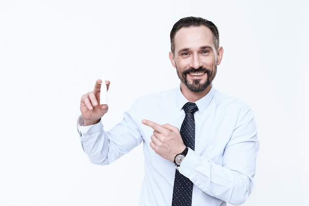 Man shows white nose drops on a white background.