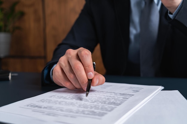 A man signing contract at the office The concept of entering into partnership