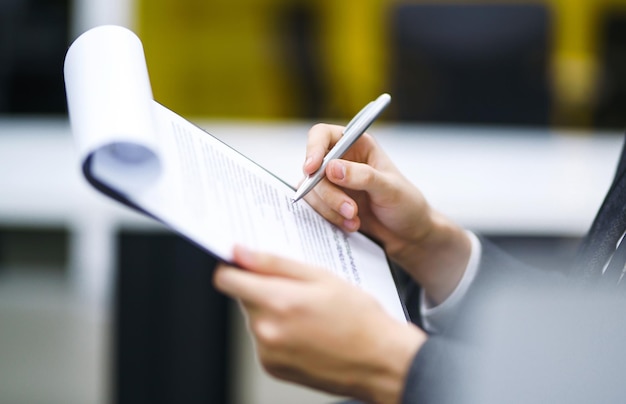 A man signs a contrac legal or business agreements Male hand with pen of office worker makes notes