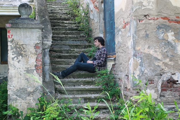 Man sit on abandoned stair