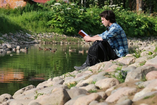 Man sit on stone river