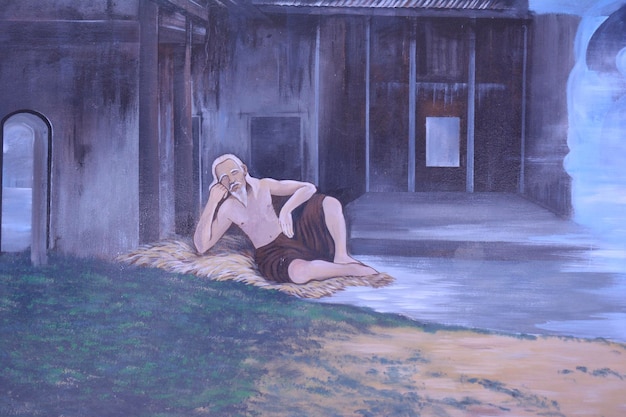 A man sits in a courtyard