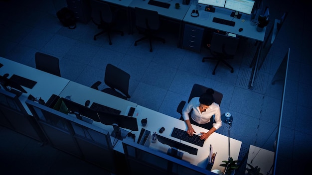 A man sits at a desk in front of a computer screen that says'it's a computer '