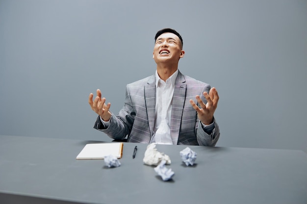 Man sits in the office emotions nervous breakdown anger gray\
background