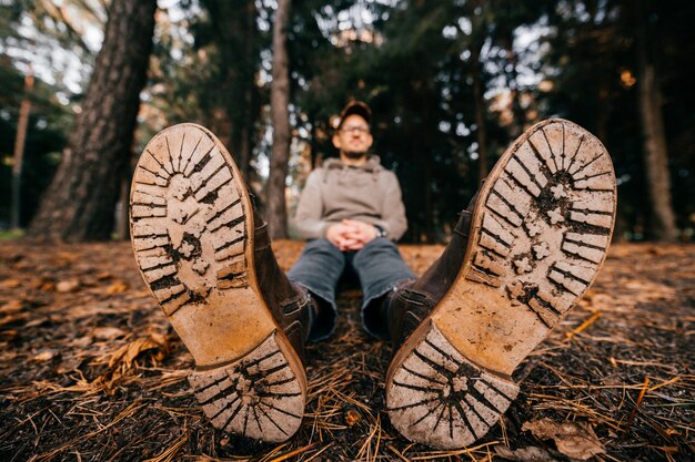 Man sitting in autumn park on ground