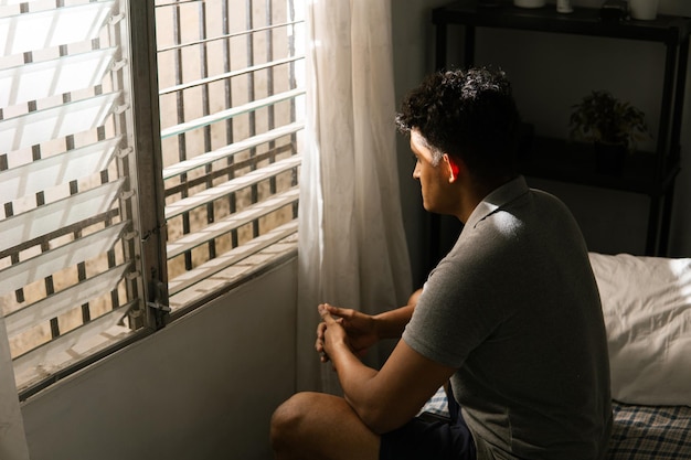 Man sitting on bed and alone home