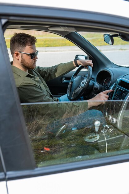 Man sitting in car using phone