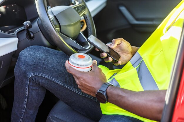 Man sitting in a car with an emergency light in his hand