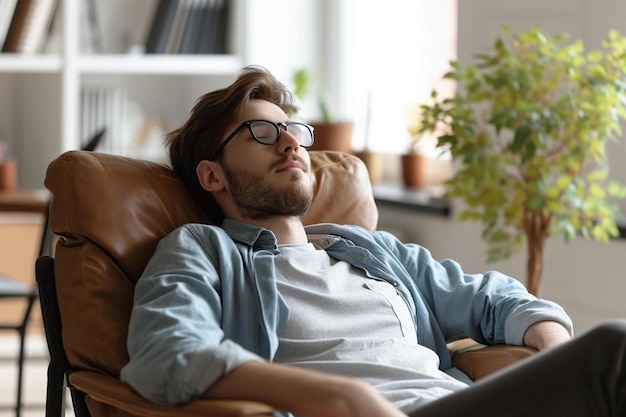 a man sitting in a chair with his eyes closed