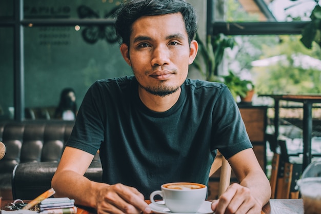 Man sitting in coffee shop for drink in coffee time