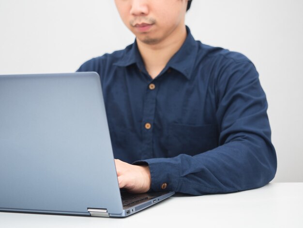 Man sitting at the desk using laptop for work white background