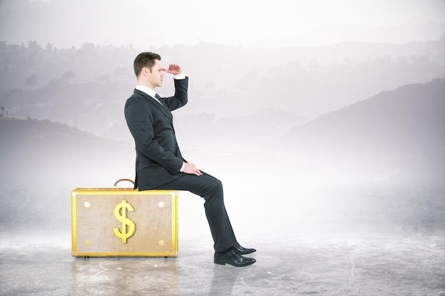 Man sitting on dollar suitcase