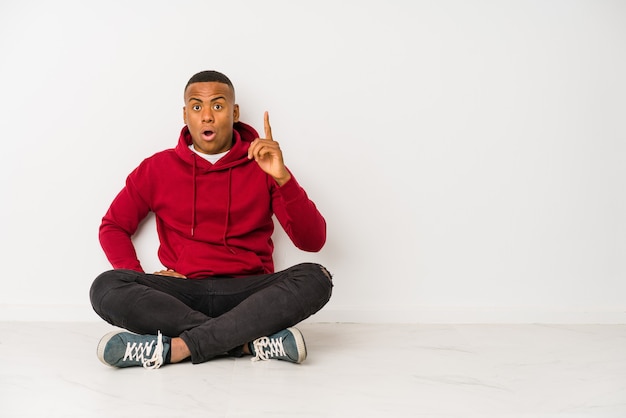 Man sitting on the floor having an idea