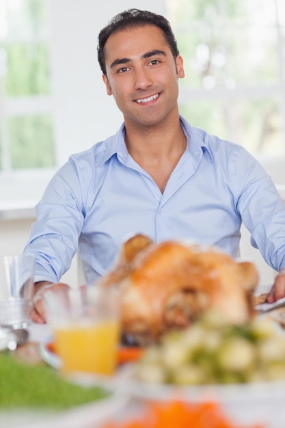 Man sitting at head of dinner table