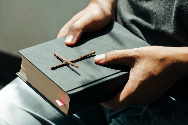 Man sitting and hold the Bible