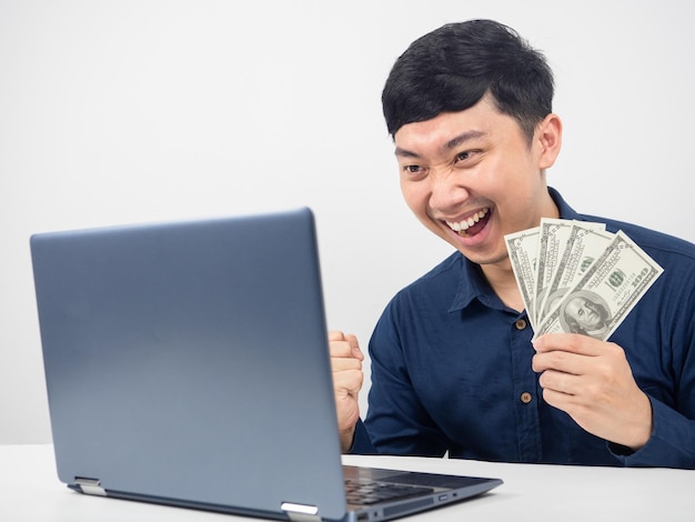 Man sitting and looking at laptop happy emotion with earn money