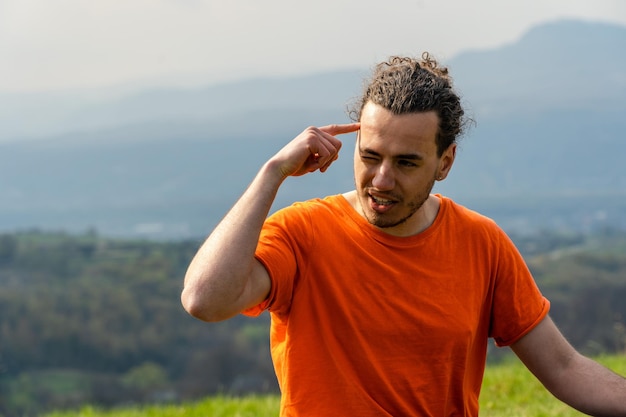 Man sitting on the mountain peak and telling something