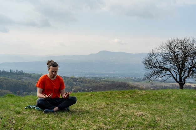 Man sitting on the mountain and telling something