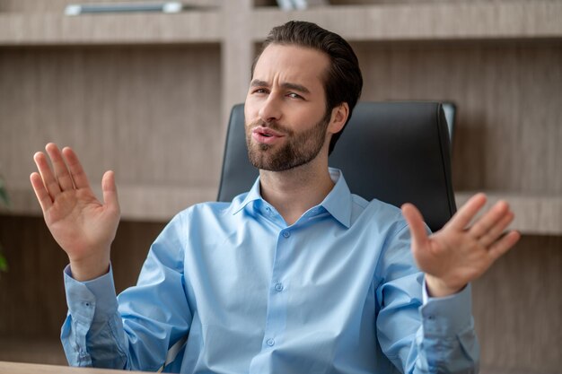 A man sitting in the office and looking contented