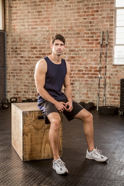 Man sitting on plyo box