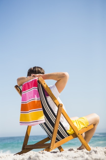 Man sitting and relaxing on deck chair