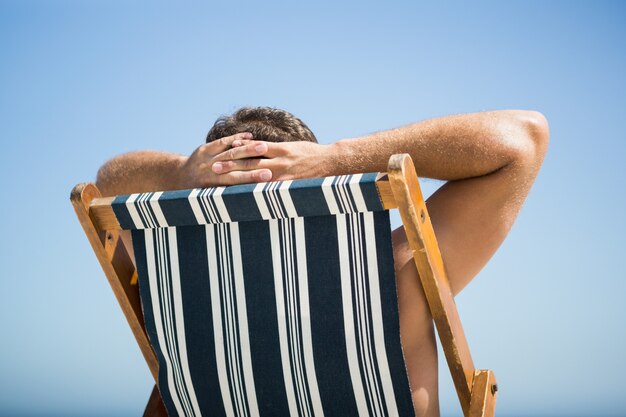 Man sitting and relaxing on deck chair