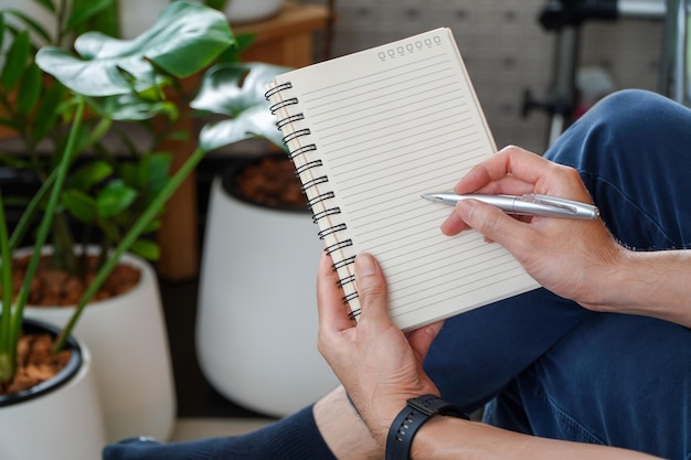 Man sitting and resting using a pen to write a notebookBusiness and education concept