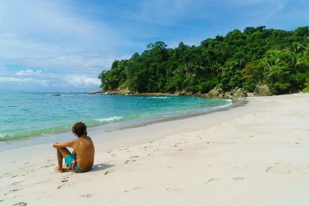 Man sitting on sand ina beach