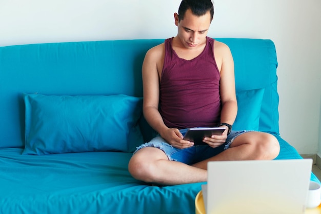 Man sitting on the sofa using a tablet