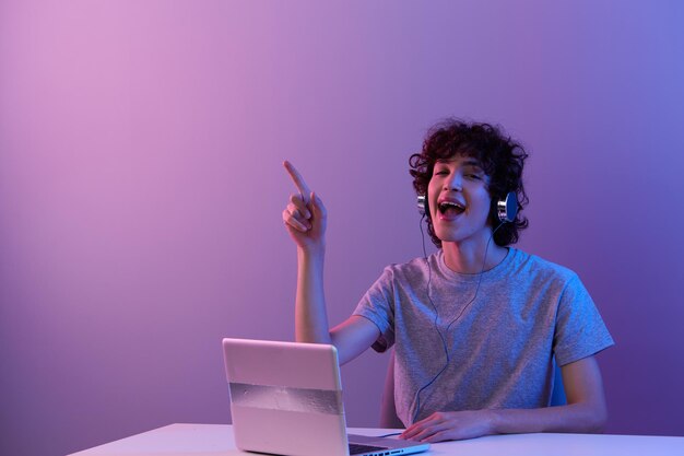 Man sitting at the table gaming laptop isolated background