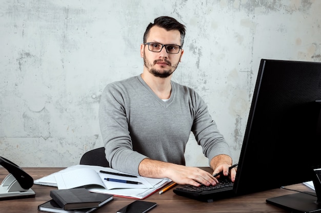 man sitting at a table in the office