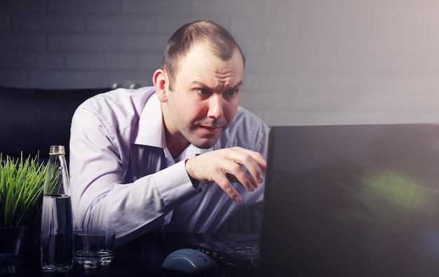 Man sitting at table and working on laptop