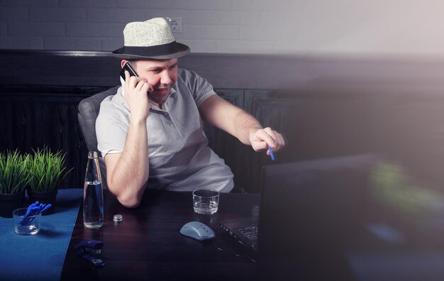 Man sitting at table and working on laptop