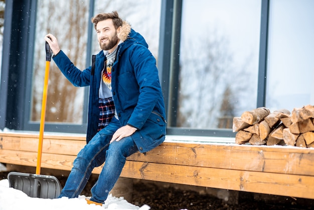 Man sitting on the terrace of the modern house during the winter