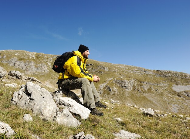 Man sitting on top of mountain