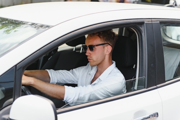 Man sitting at the wheel of electric car