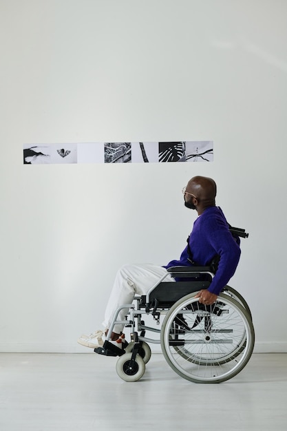 Man sitting in wheelchair at gallery