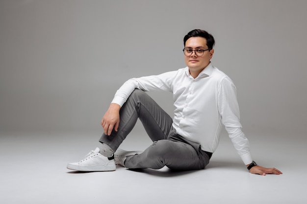 a man sitting on a white background