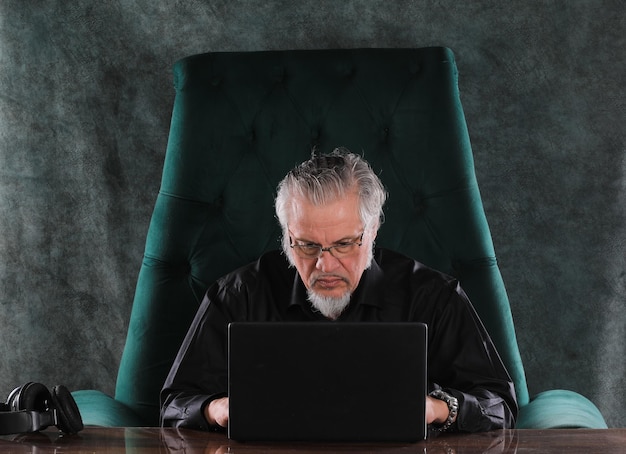 man sitting with laptop at night