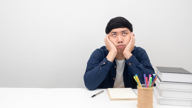 Man sitting at workplace desk gesture bored to working