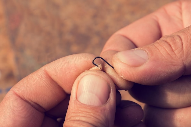 Man skewer a worm on a steel hook