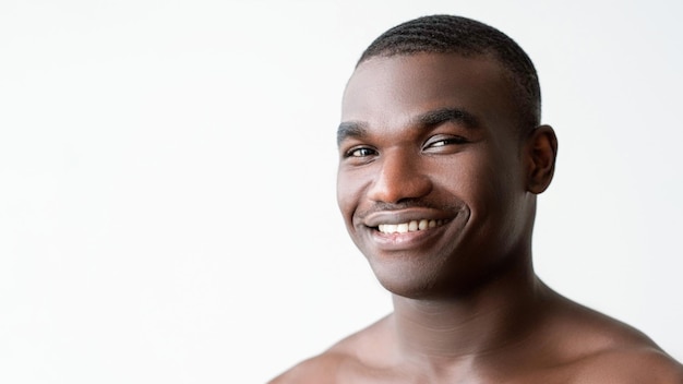 man skincare hygiene treatment happy handsome shirtless guy with soft smooth clean face skin after