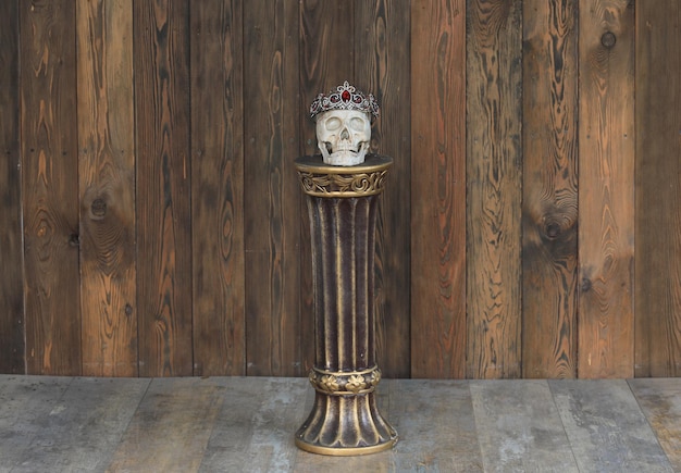 man skull with crown on stand