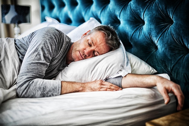 Man sleeping on bed in bedroom