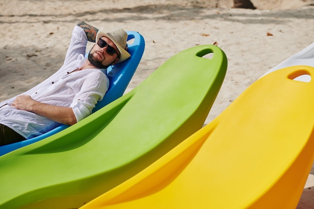 Man sleeping on chaise-lounge