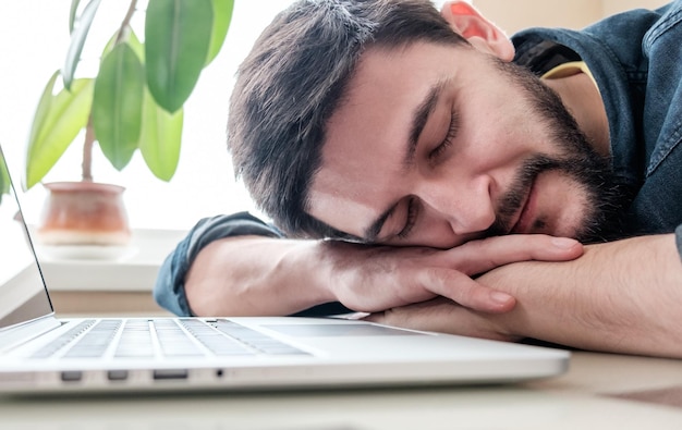 Man sleeping with his laptop