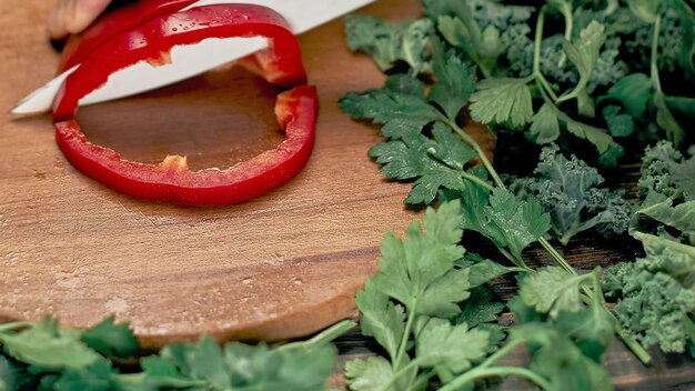 Man slicing paprika on the kitchen table