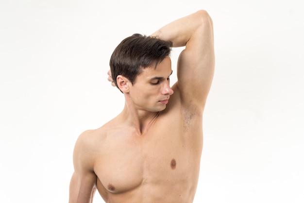 Photo man smelling his armpit with white background