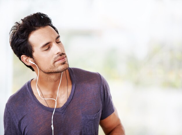 man smile and earphones with eyes closed for music radio or streaming online on mockup male person thinking and listening to audio on headphones for ideas podcast and mental health wellness