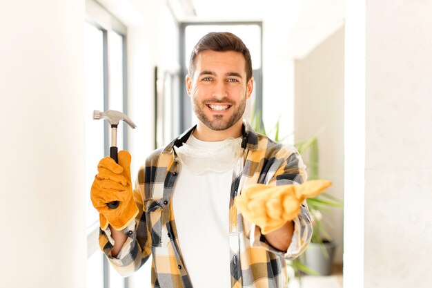 man smiling happily with friendly, confident, positive look, offering and showing an object or concept